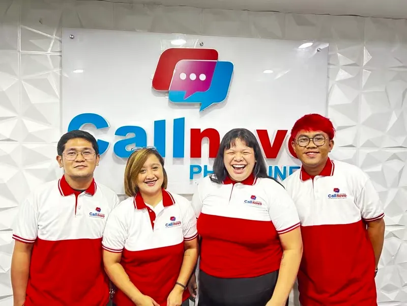 Callnovo Philippines team at office reception with company logo