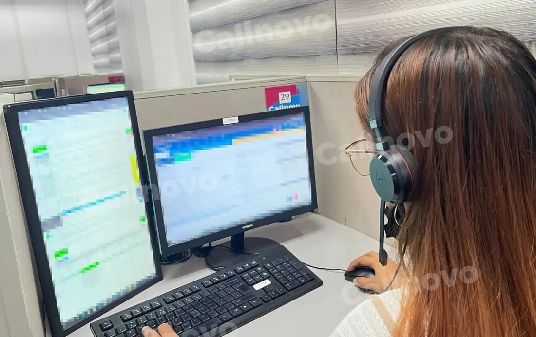 A Callnovo support agent working across channels at a dual-monitor workstation with a headset