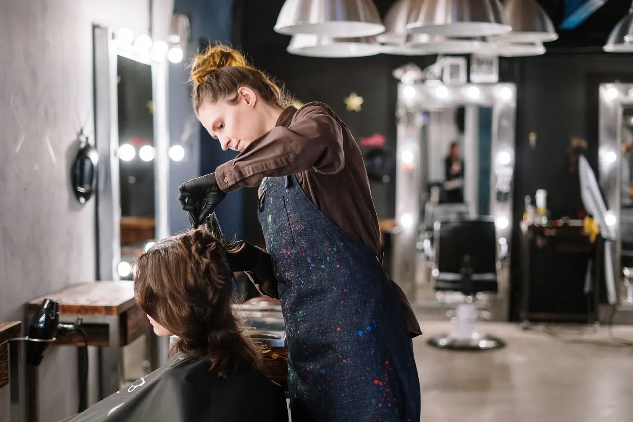 A stylist working on a client in a modern hair salon