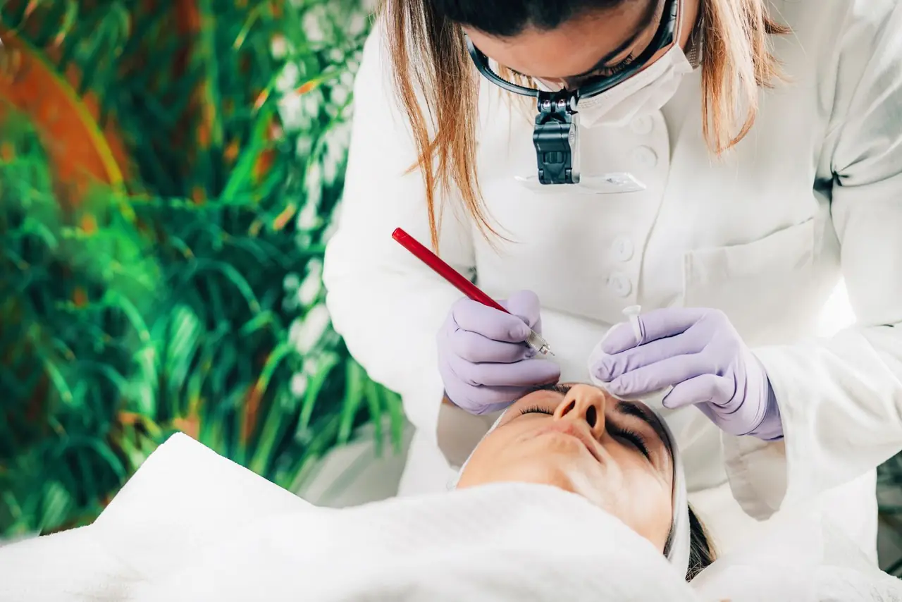 A beautician performs a cosmetic procedure on a client in a serene spa environment.