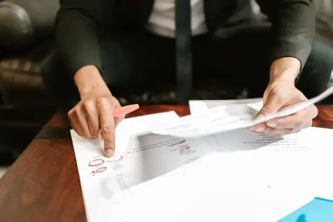 A businessman analyzing financial documents with important data and figures on a desk, ideal for business anal